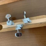 Closed up view of 3 closed gear tuners pegs where they attach to the handcrafted Cohiba cigar box guitar