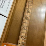 Close-up view of neck and fretboard of Cohiba cbg by Bob's 3 Stringers