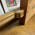 Closed up view top back fretboard with output jack of Cohiba Cigar box guitar