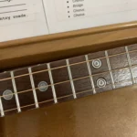 Close-up view of neck and fretboard of Romeo Y Julieta cbg by Bob's 3 Stringers