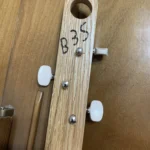 Front view of 3 string guitar with wooden headstock of Romeo Y Julieta handcrafted by Bob.
