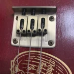 Close-up of the threaded rod bridge of Fat Bottom Betty #43, handcrafted by Bob