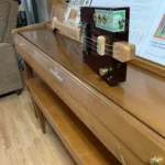 Side view of the whole body of the La Palina cigar box guitar handcrafted by Bob.