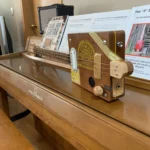Side view of the whole body of the H_UPMANN cigar box guitar handcrafted by Bob.