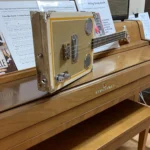 Side view of the whole body of the Craft/Stripped cigar box guitar handcrafted by Bob.
