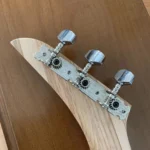 Closed up view of 3 closed gear tuners pegs where they attach to the handcrafted Craft/Stripped cigar box guitar