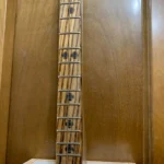 Close-up of the Oak neck with Zebra wood fretboard Burned fret dot markers Burned in side fret markers H Upmann Diddley Bow