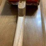 Close-up of the gloss finish on the neck of #57 Bolivar Diddley Bow, handcrafted by Bob.