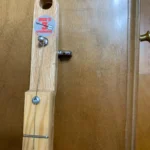 Closed up view of 1 Close-Up of the High-G Tuned One-String Diddley Bow Cigar Box Guitar where they attach to the handcrafted Bolivar Diddley Bow cigar box guitar