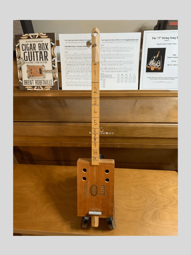 Front, vertical view of Alfred Dunhill Diddley Bow cigar box guitar by Bob's 3-Stringers