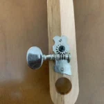 Closed up view of closed gear tuner where they attach to the handcrafted Alfred Dunhill Diddley Bow cigar box guitar