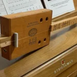 Side view of the whole body of the Alfred Dunhill Diddley Bow cigar box guitar handcrafted by Bob.