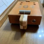 close up of the bottom of the Alfred Dunhill Diddley bow cigar box guitar