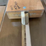 close up of the bottom of the Alfred Dunhill Diddley bow cigar box guitar