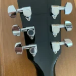 Closed up of 6 chrome closed gear tuners, Monte Cristo.