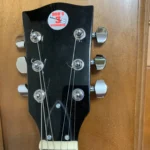 Front view of 6 string guitar with 6 chrome closed gear tuners