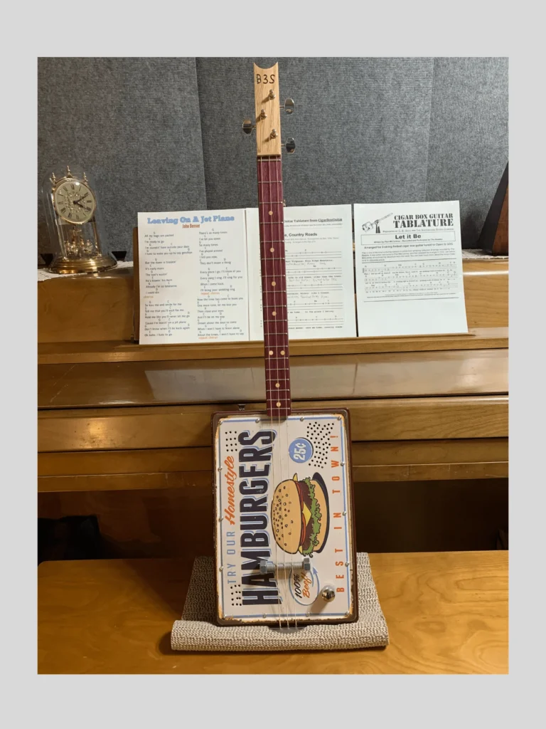Front, vertical view of #62 Wild Raspberry Box Guitar by Bob's 3-Stringers