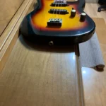 Bottom part of #3 Solid Body Guitar with 2 single wound pickups, Antique Brass volume and tone knobs , 1/4" output jack, Adjustable antique brass hard tail bridge, 2 strap buttons , 3 acoustic strings tuned GDG ,by Bob.