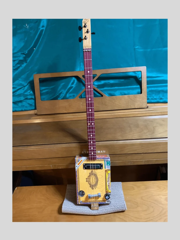 Front, vertical view of #63 Partagas cigar box guitar by Bob's 3-Stringers