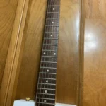 Front view of 6 closed gear tuners with Maple neck with walnut wood fretboard of 6 String Guitar