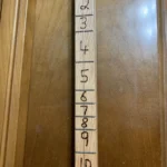 Closed up of Burned in numbers Fret markers with diddley bow guitar.