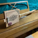 Side view of the whole body of the #66 Diddley Bow Guitar handcrafted by Bob.