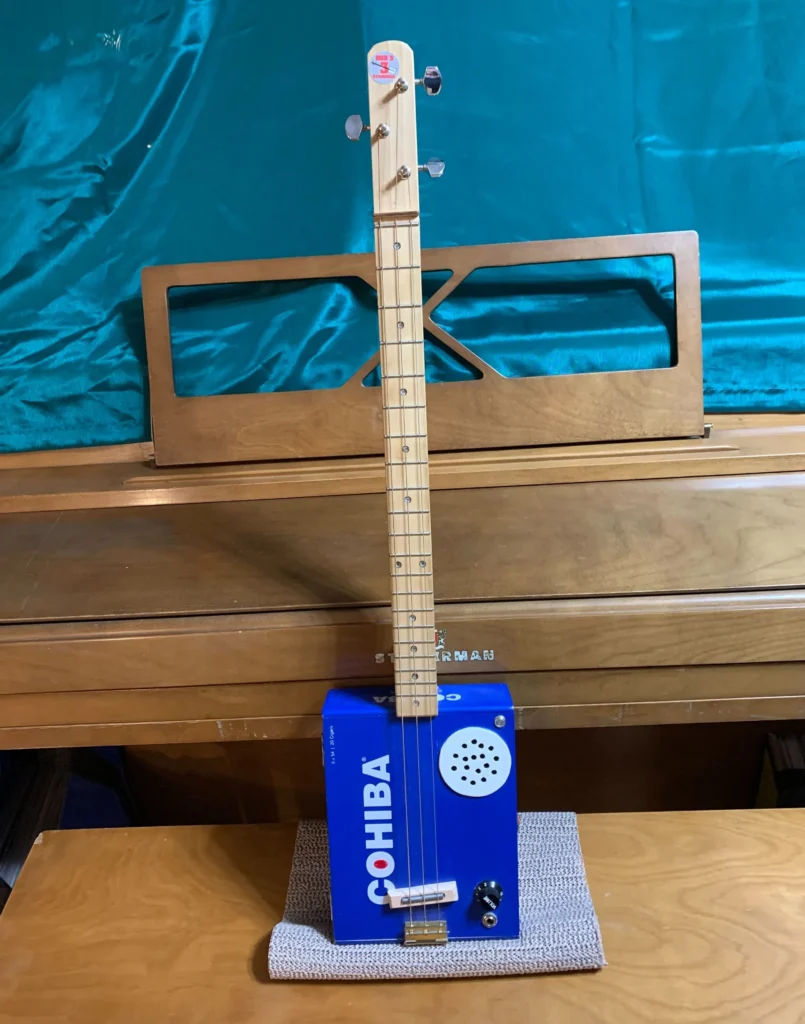 Front, vertical view of #8 Cohiba cigar box guitar by Bob's 3-Stringers